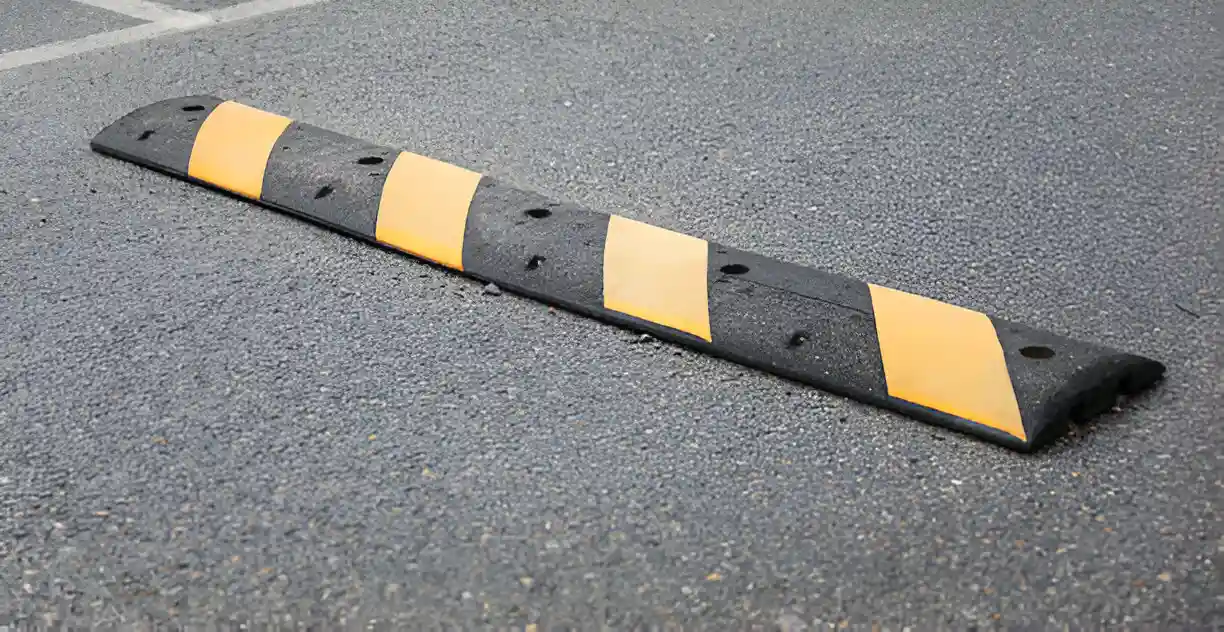 A black and yellow striped speed bump.
