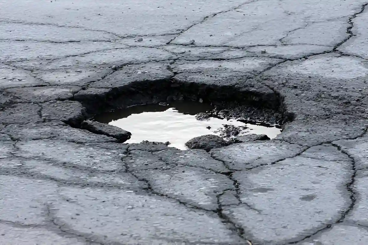 Crumbling concrete in the early stages of forming a pothole